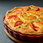 Close-up photo of classic quiche lorraine pie with tomatoes